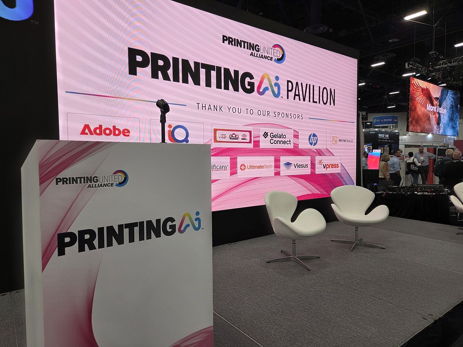 The PRINTING AI Pavilion stage, with Vpress among the sponsors on screen