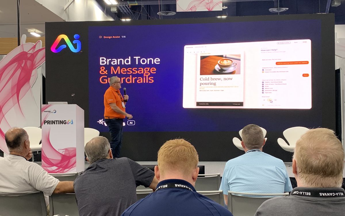 Kelvin Bell presenting Design Assist on stage, with a slide on brand tone and message guardrails